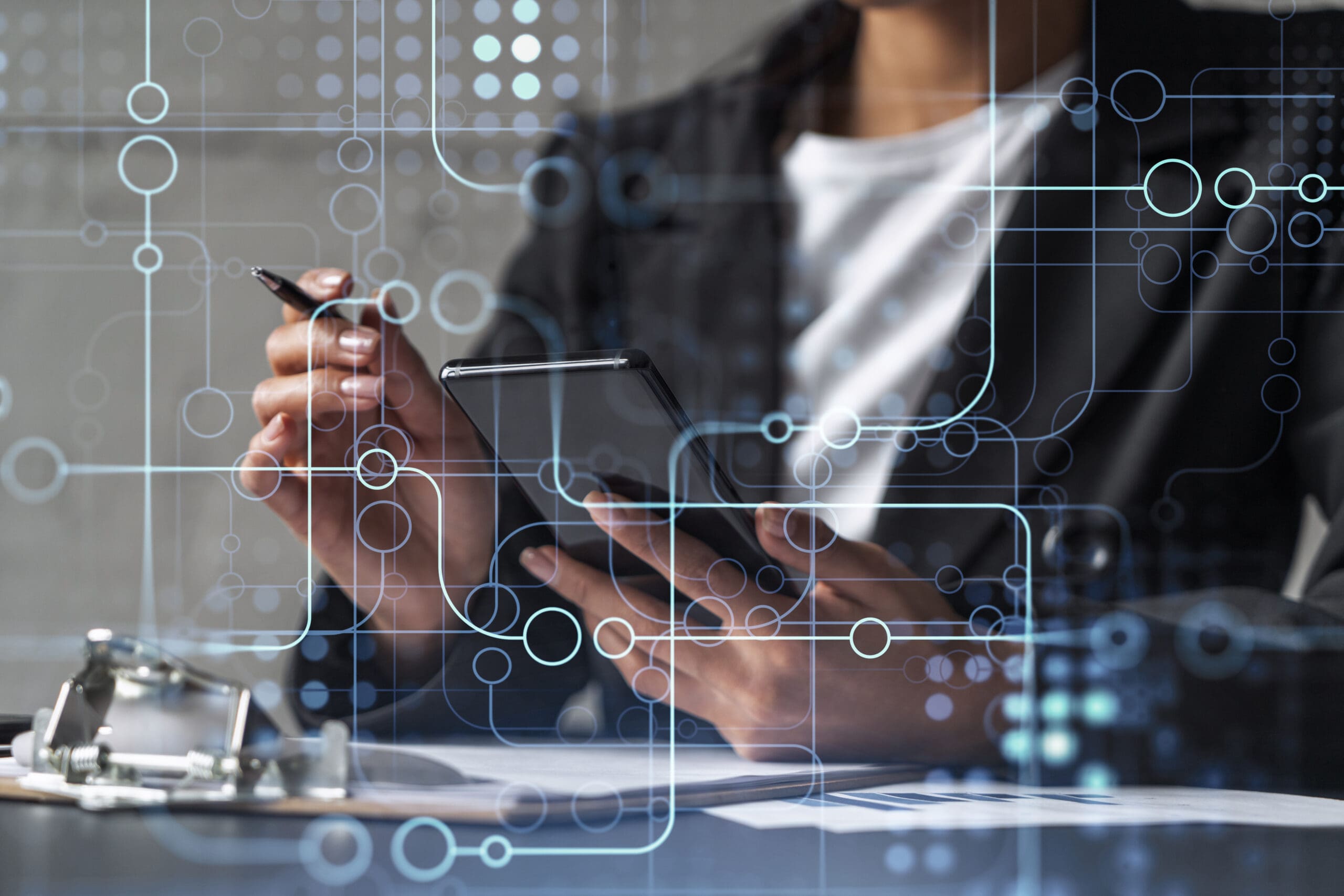 person looking at phone, holding pen