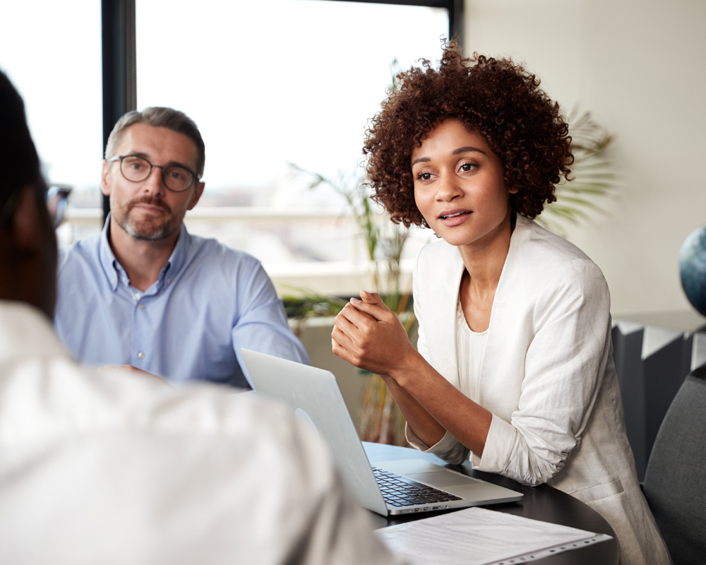 Advisor sitting with clients at a table